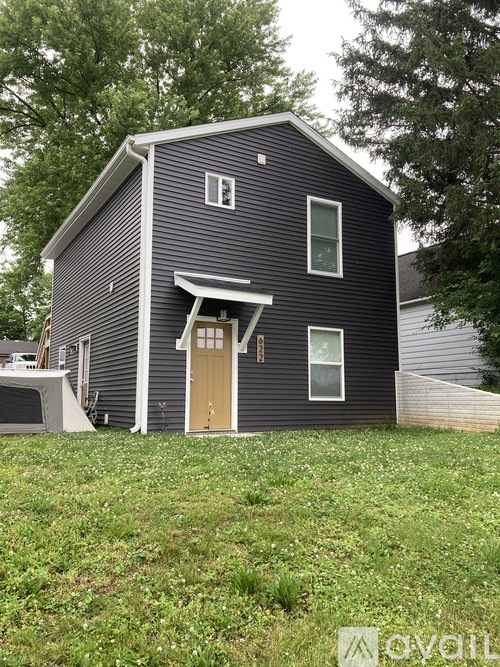 A house with a grey exterior and a brown door.