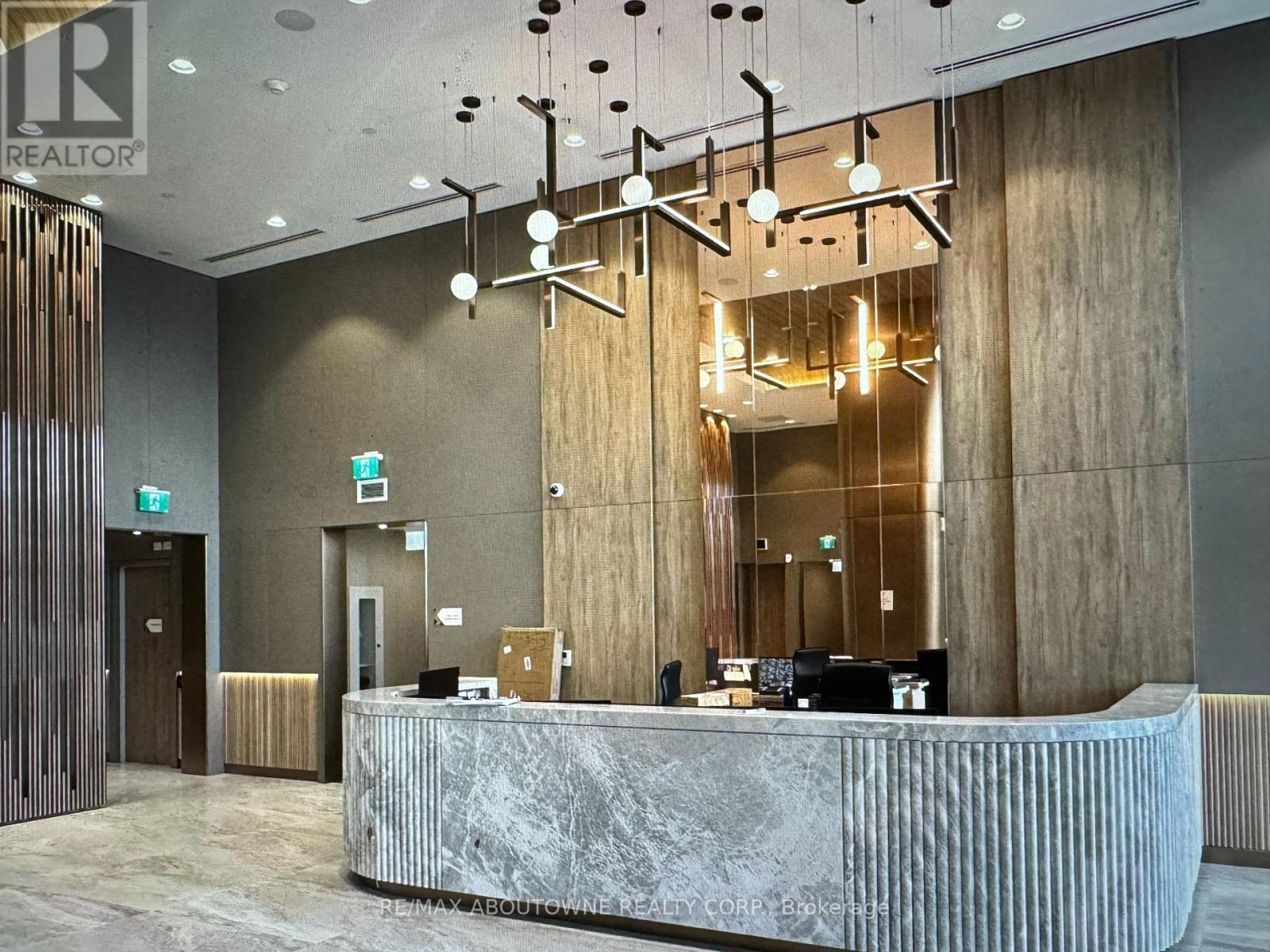 A reception area with a marble counter and a wooden door.
