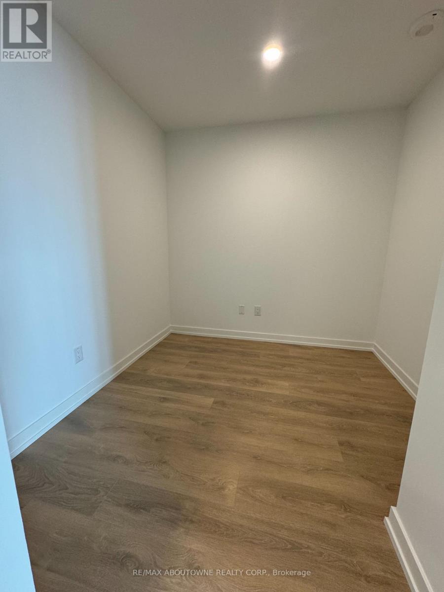 A room with wooden flooring and white walls.