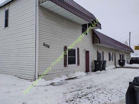 A house with a brown roof and a sign that says "206" on the side.