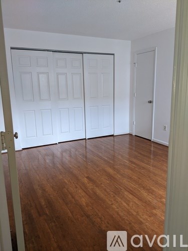 A room with a white door and a white wall.