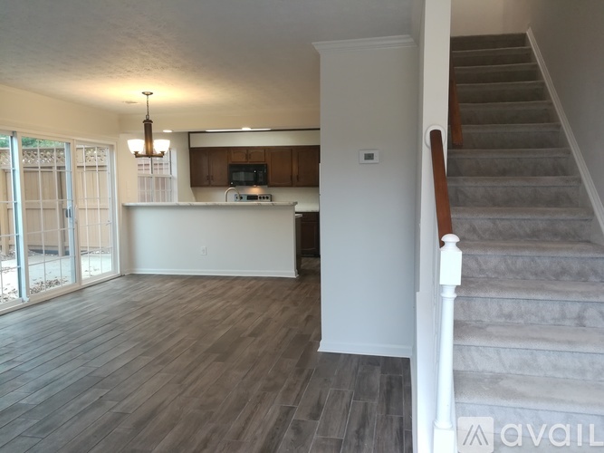 A living room with a staircase leading to the upper floor.