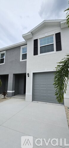A modern house with a grey garage door.