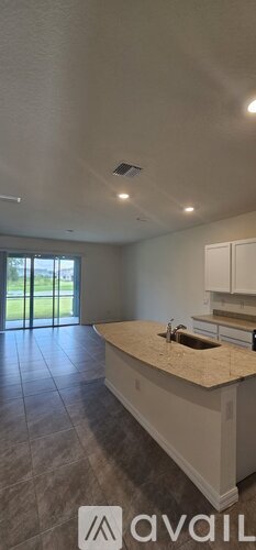 A kitchen with a granite countertop and a sink.