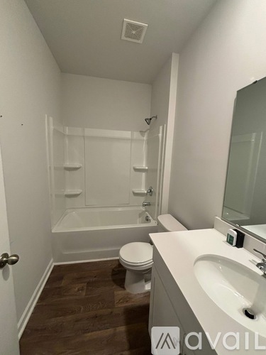 A bathroom with a toilet, sink, and bathtub.