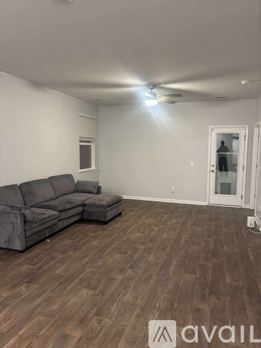 A room with a ceiling fan and a door.