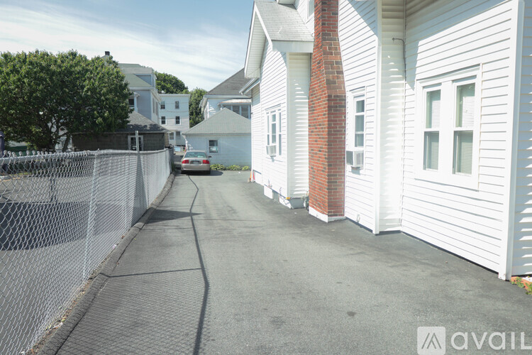 A white house with a red brick chimney is on the right side of the image.