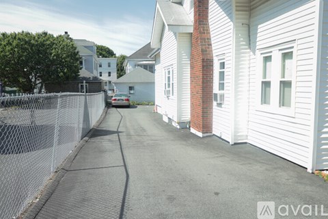 A white house with a red brick chimney is on the right side of the image.