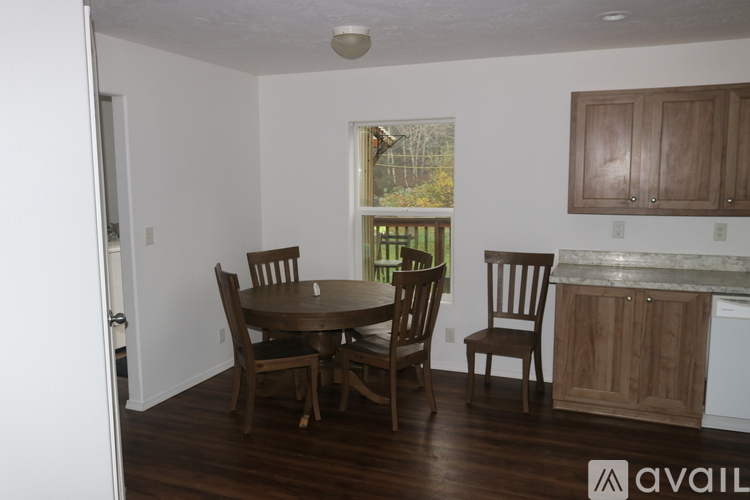 A dining room with a table and chairs.