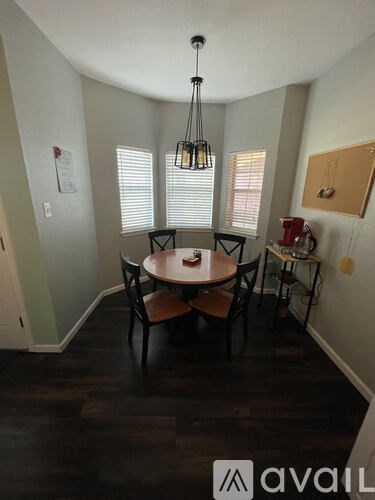 A dining room with a table and chairs.