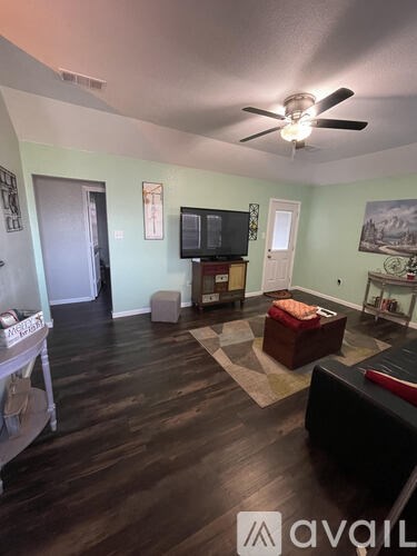 A living room with a television and a couch.
