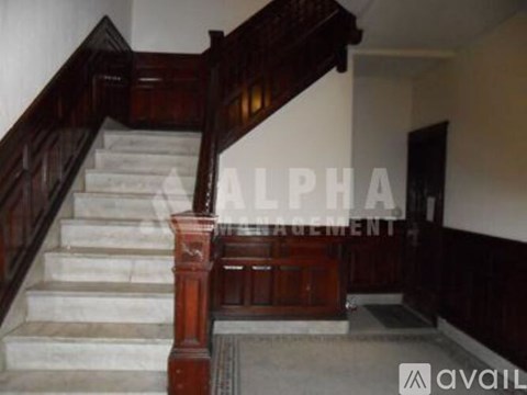 A staircase with a wooden banister and white steps.