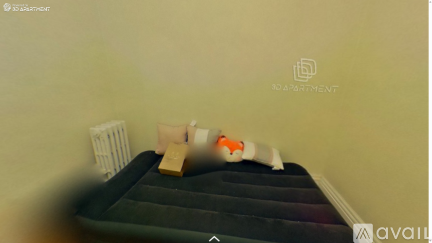 A bed with a green mattress and a white pillow is in a room.