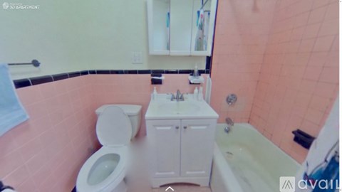 A bathroom with a toilet, sink, and bathtub.