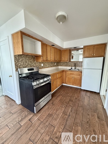 A kitchen with wooden cabinets and a black stove top oven.