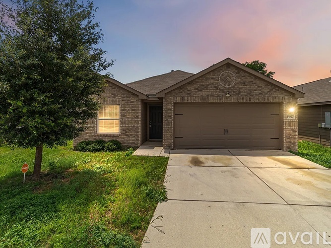 A house with a garage door and a circular emblem above it.