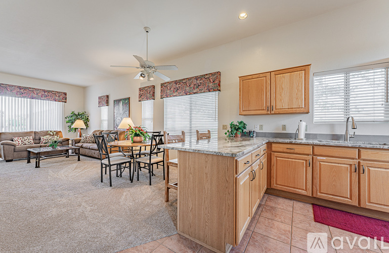 A kitchen with wooden cabinets and a dining table with chairs.