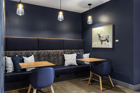 A dining area with a table and chairs.