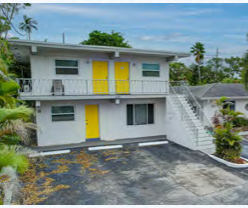 A two-story house with yellow doors and a balcony.