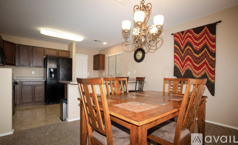 A dining room with a wooden table and chairs.
