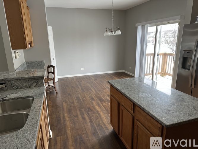 A kitchen with wooden floors and a countertop.