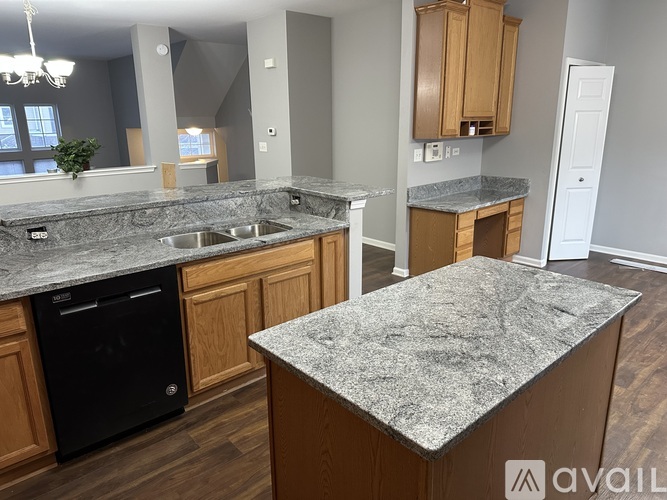 A kitchen with wooden cabinets and a refrigerator.