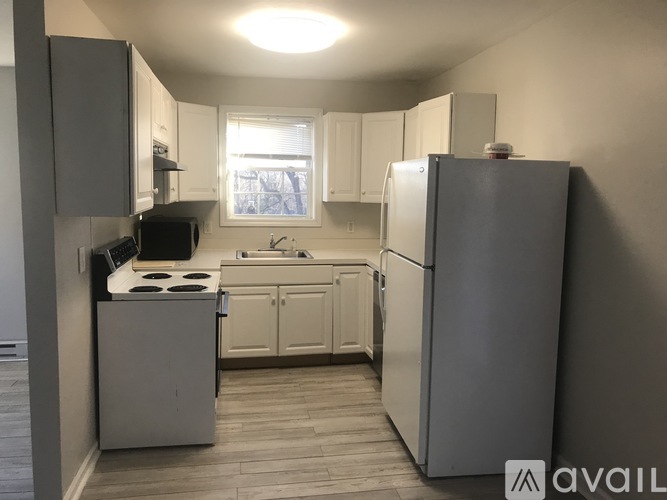 A kitchen with a refrigerator, stove, and sink.
