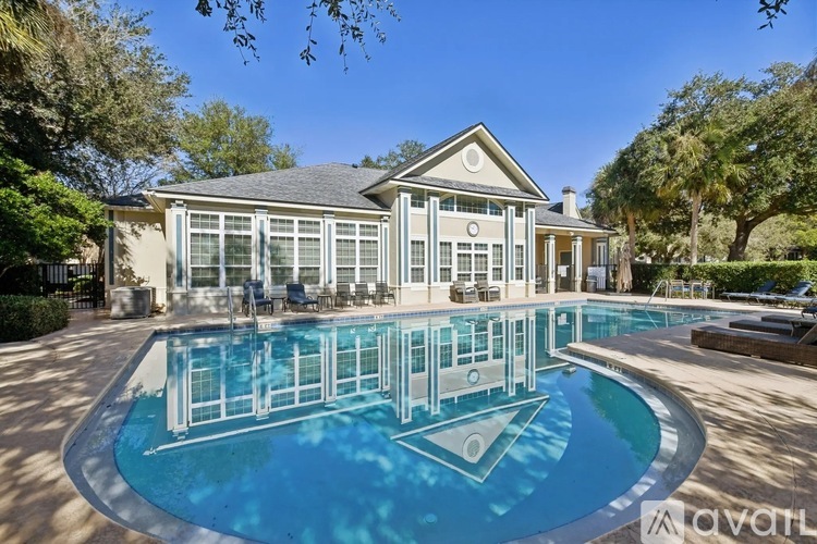 A large house with a pool in front.