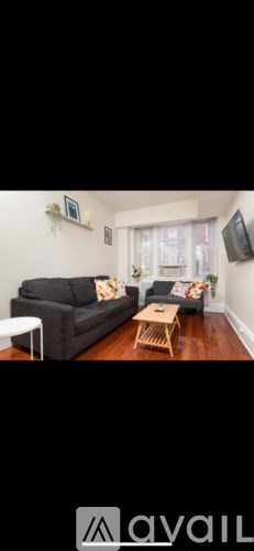 A living room with a grey couch and a wooden coffee table.