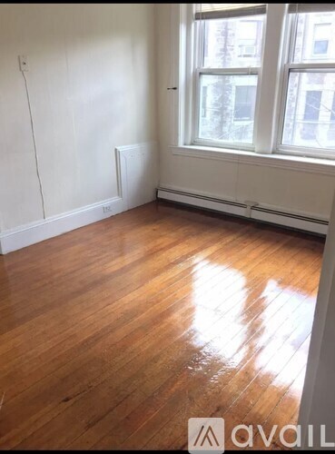 A room with wooden floors and a window.