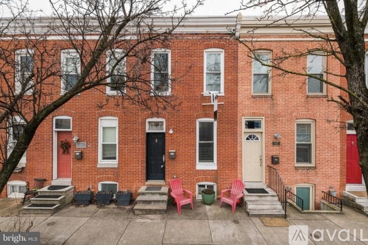 A red brick house with a black door and a white door.