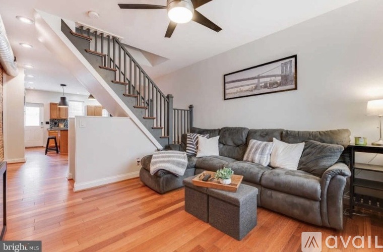 A living room with a grey couch and a wooden coffee table.
