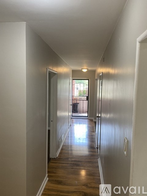 A long hallway with a door at the end.