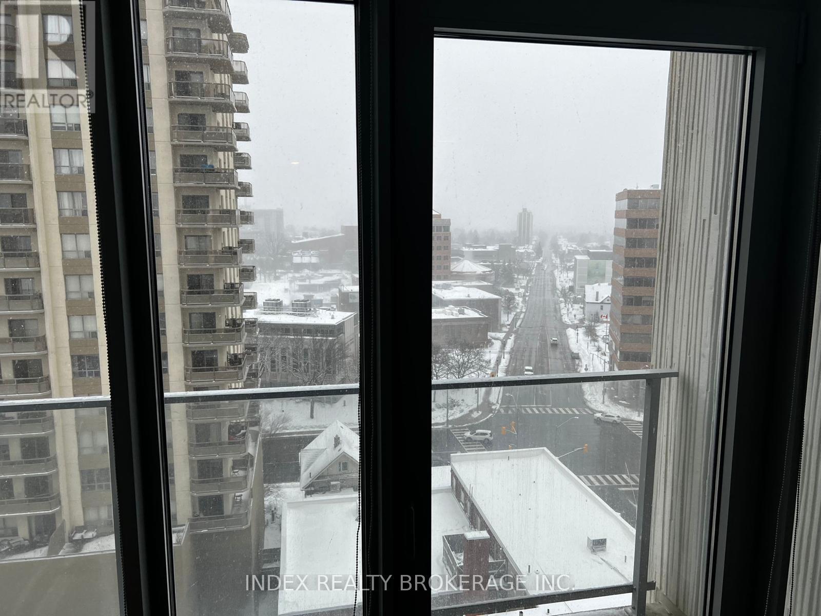 A view of a snowy cityscape from a window.