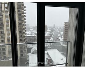 A view of a snowy cityscape from a window.