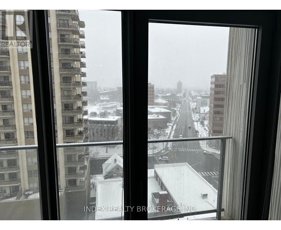 A view of a snowy cityscape from a window.