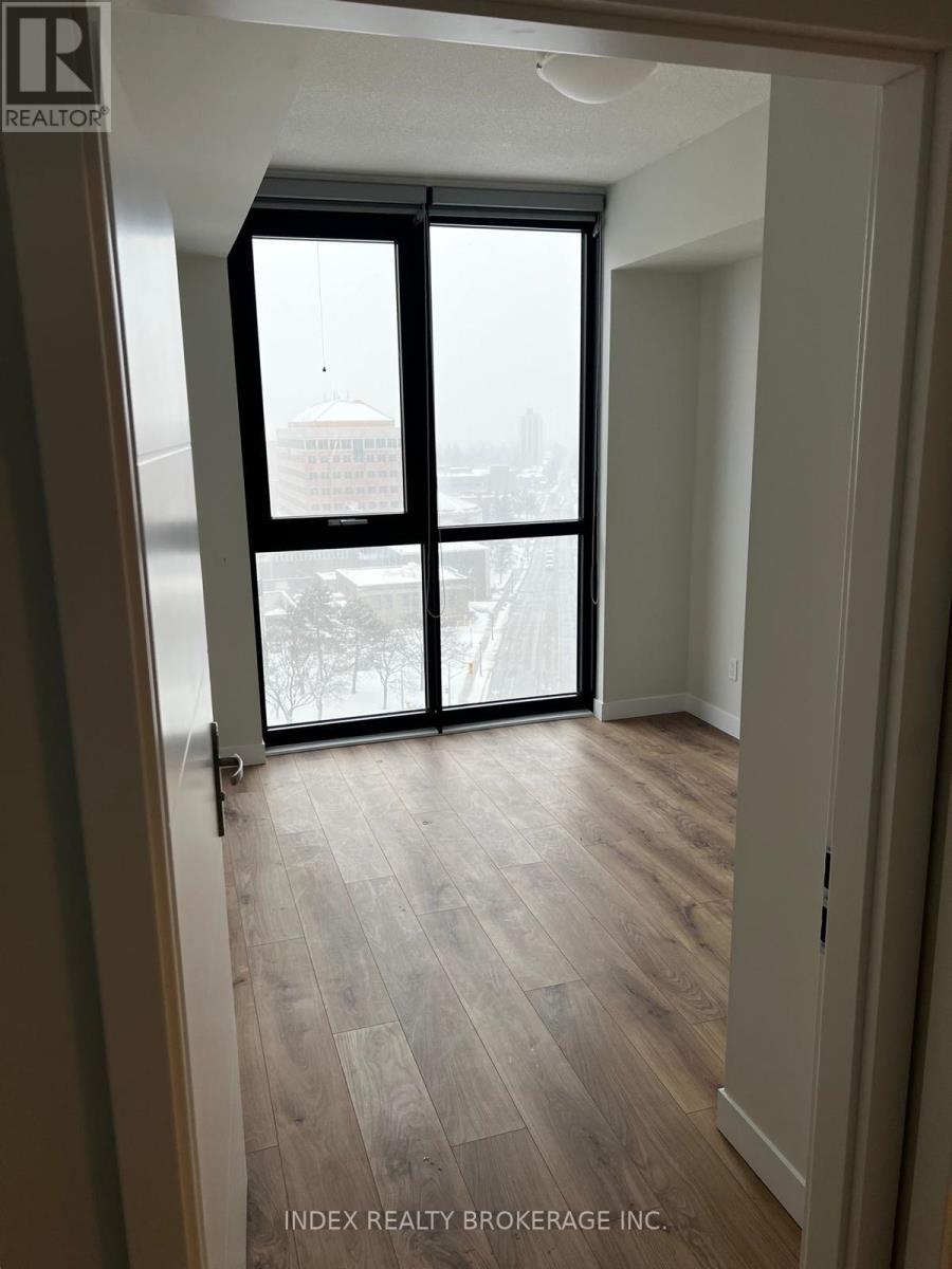 A room with a view of a cityscape through a large window.