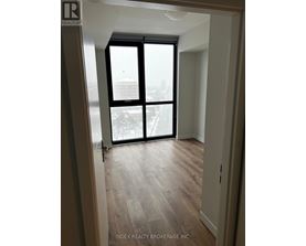 A room with a view of a cityscape through a large window.