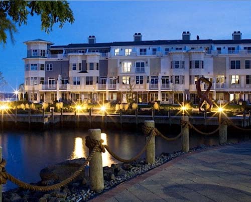 a row of buildings next to a river at night