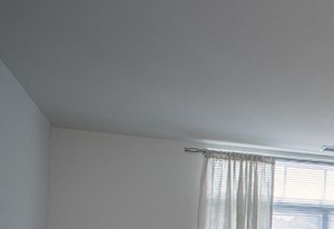 a bedroom with a bed and a chair and a dresser