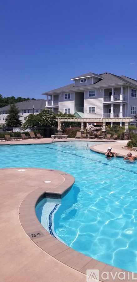 A swimming pool in front of a large building.