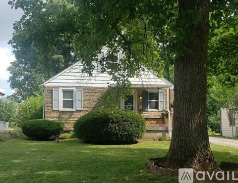 A house with a tree in front of it.
