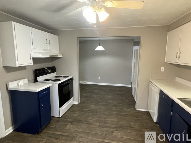 A kitchen with a stove, oven, and cabinets.