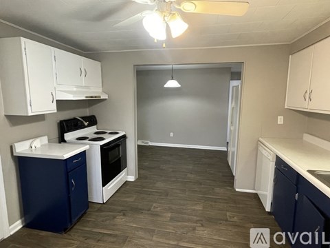 A kitchen with a stove, oven, and cabinets.