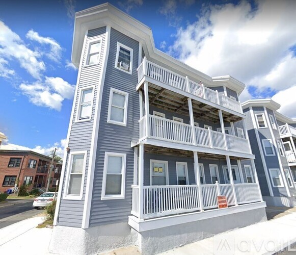 A two-story building with a balcony on the second floor.