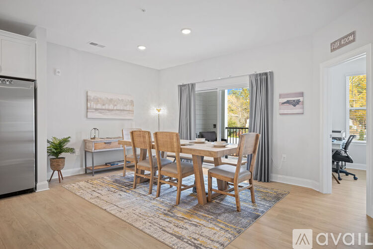 A dining room with a table and chairs.