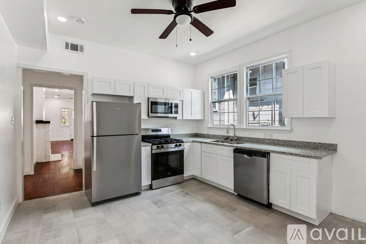 A modern kitchen with a refrigerator, stove, and oven.
