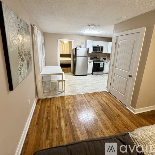 A kitchen with a refrigerator, oven, and microwave.
