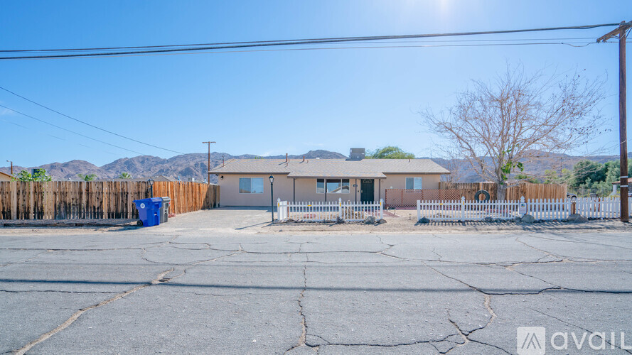 A house with a cracked ground in front of it.
