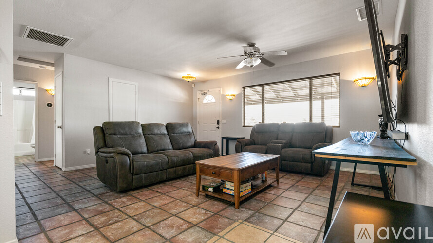 A living room with a grey sofa and a wooden coffee table.